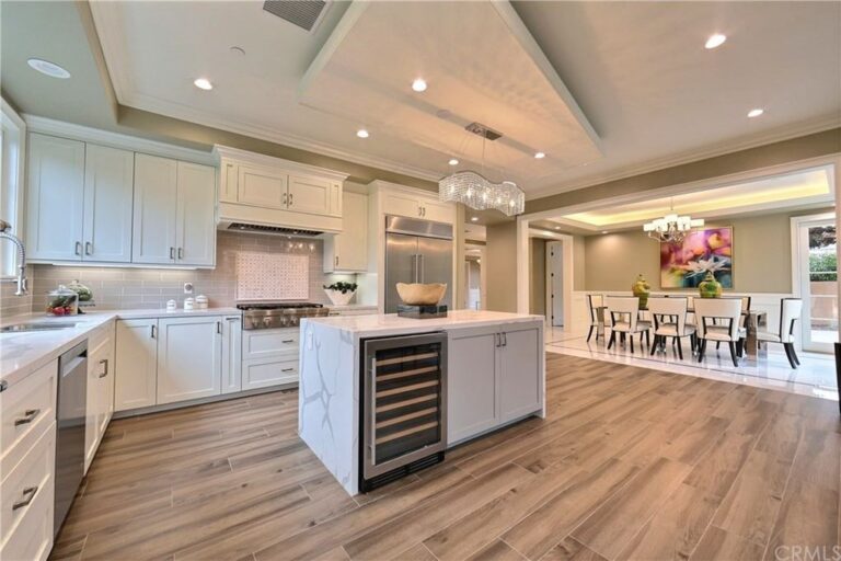 white and beige themed L-shaped kitchen with an island